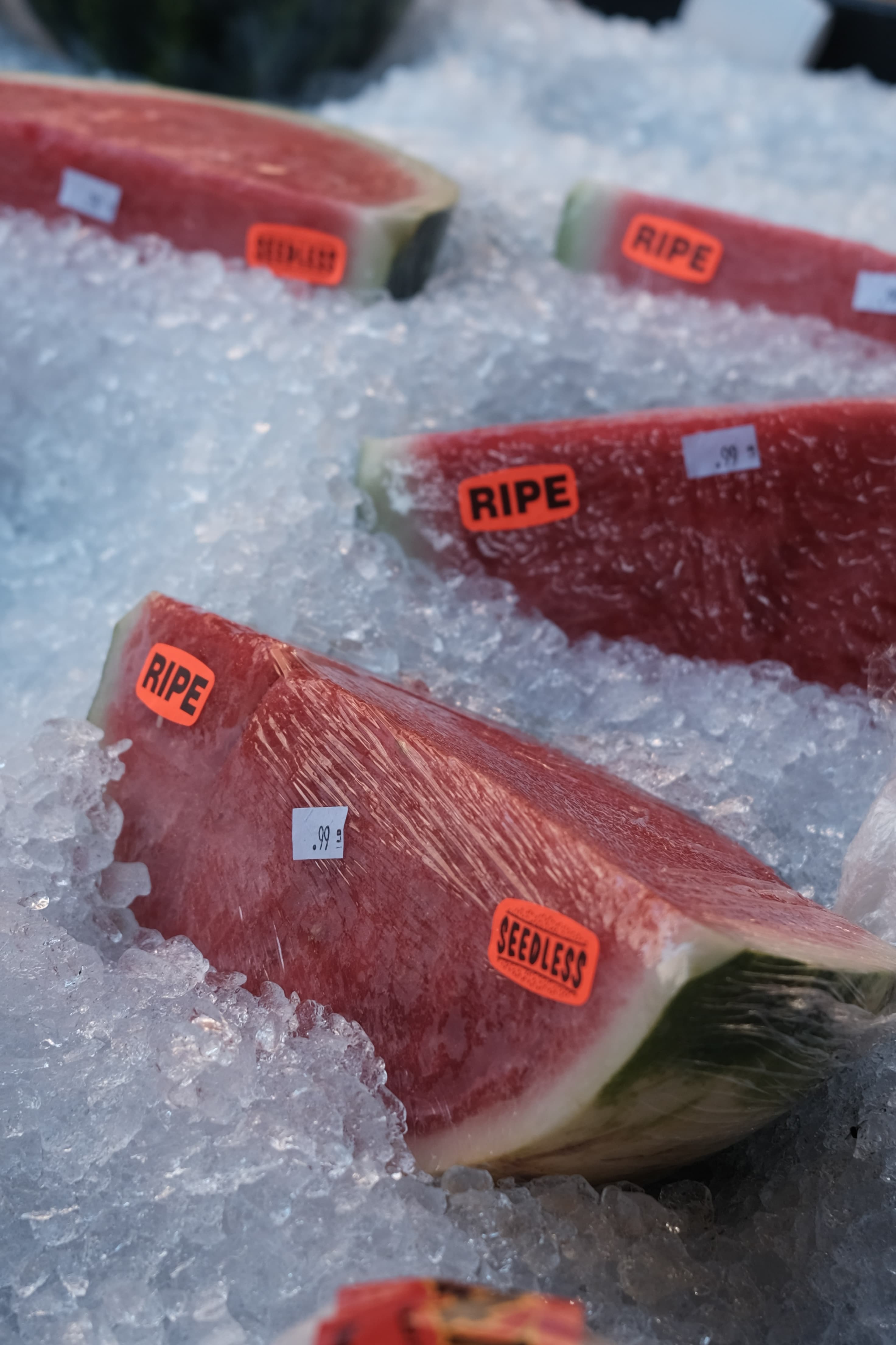 Watermelon wedges on crushed ice, labelled ripe and seedless